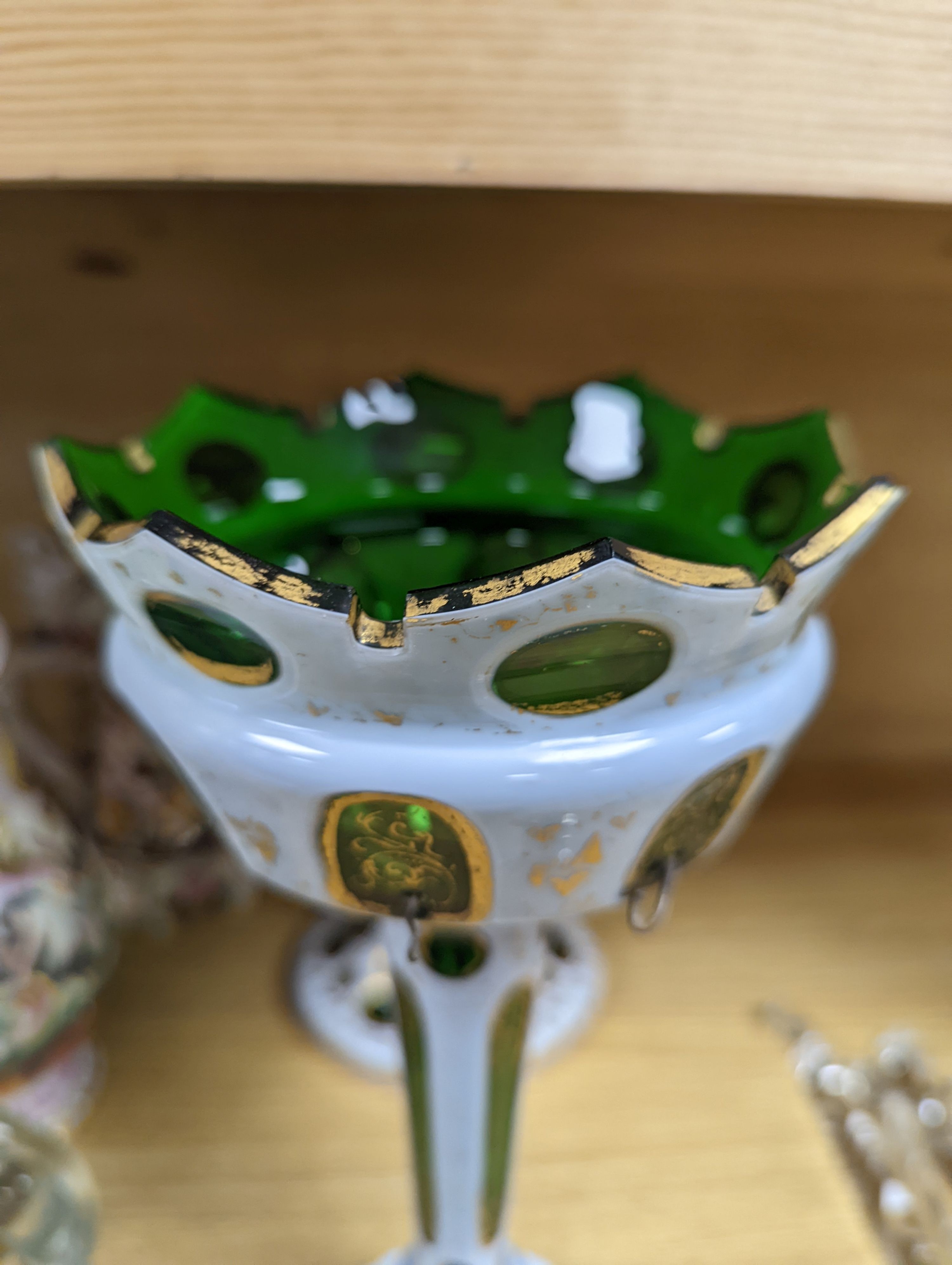 A 19th century overlaid green glass comport, 24cm high, and a similar table lustre